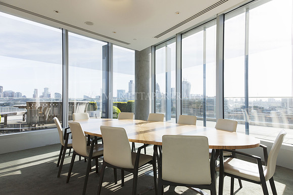 Round table in sunny highrise business conference room